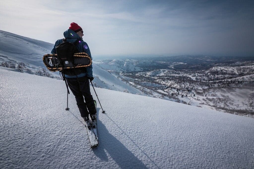 A ski tourer climbs the upper Akaigawa route on Yoichi-dake above snowy valleys