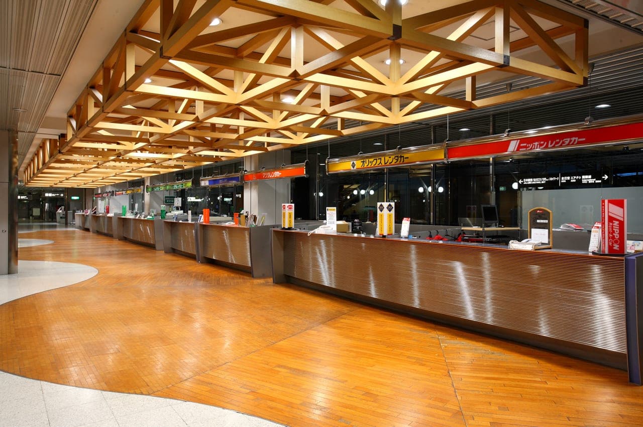 Car rental counters line the arrivals hall at New Chitose Airport