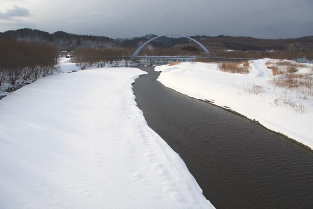 The Shitakara River runs between snowy banks in the old Akan town area, home of Akan Royal Valley
