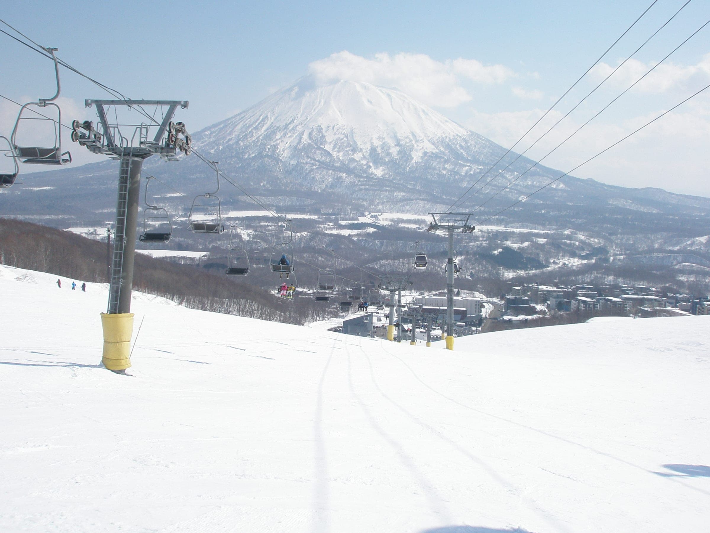 Mt. Yotei rises over the valley beyond a chairlift on the upper slopes of Grand Hirafu