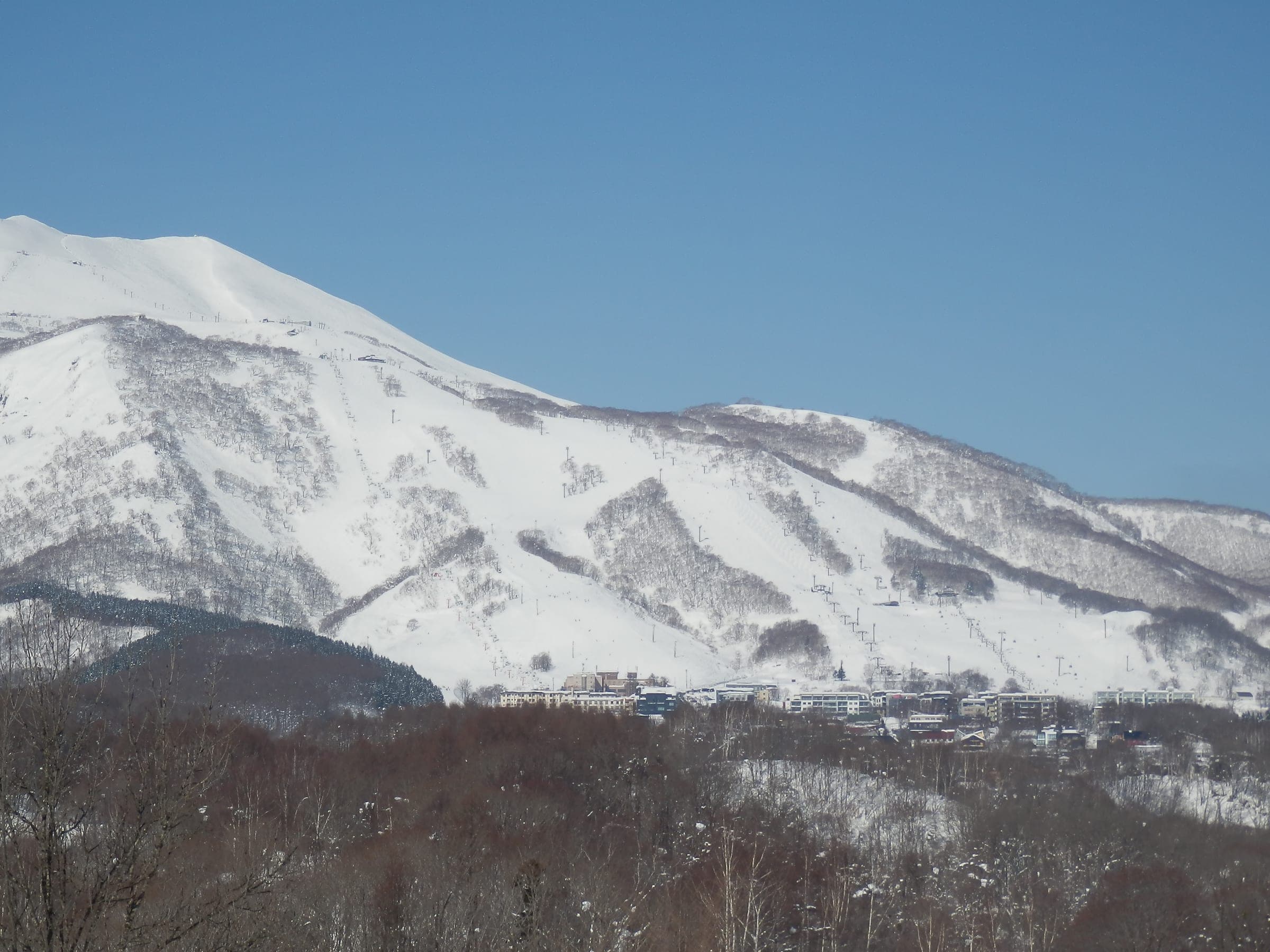 Grand Hirafu's runs streak the snowy face of Niseko Annupuri, seen from near JR Hirafu Station