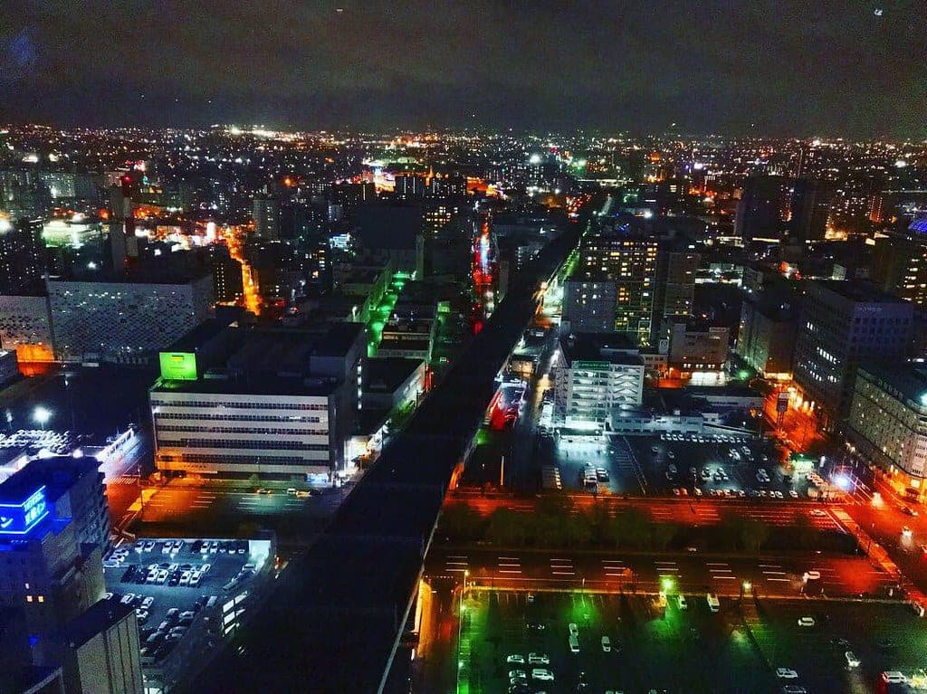 Sapporo's lit streets at night from a high floor of JR Tower Hotel Nikko Sapporo