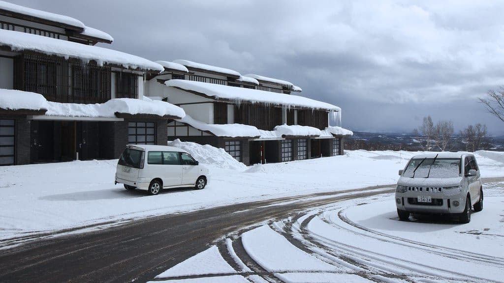 Snow piles on the eaves of the Edo-style Kasara townhouses at Niseko Village