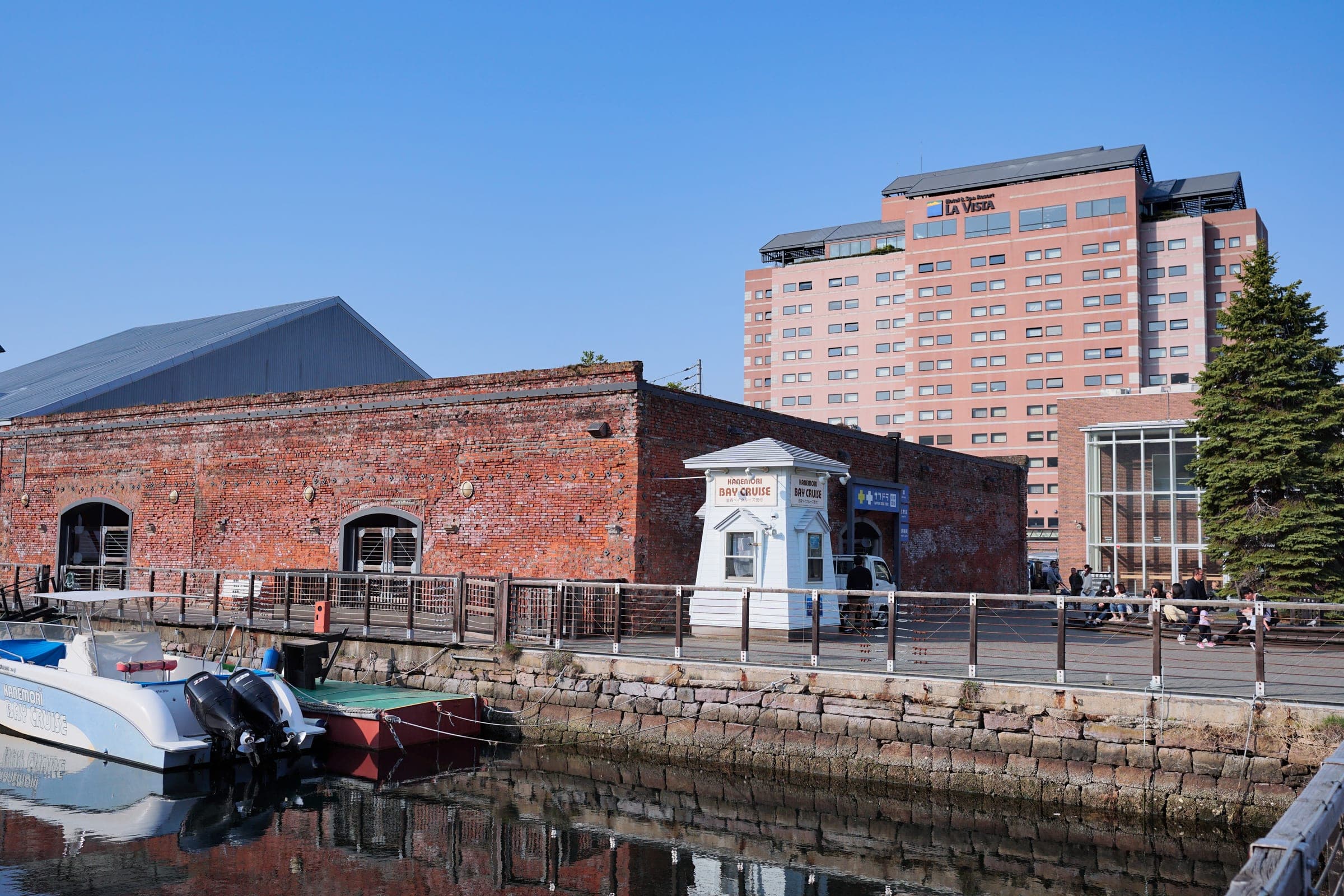 Kanemori Red Brick Warehouse on the harbour with La Vista Hakodate Bay rising behind