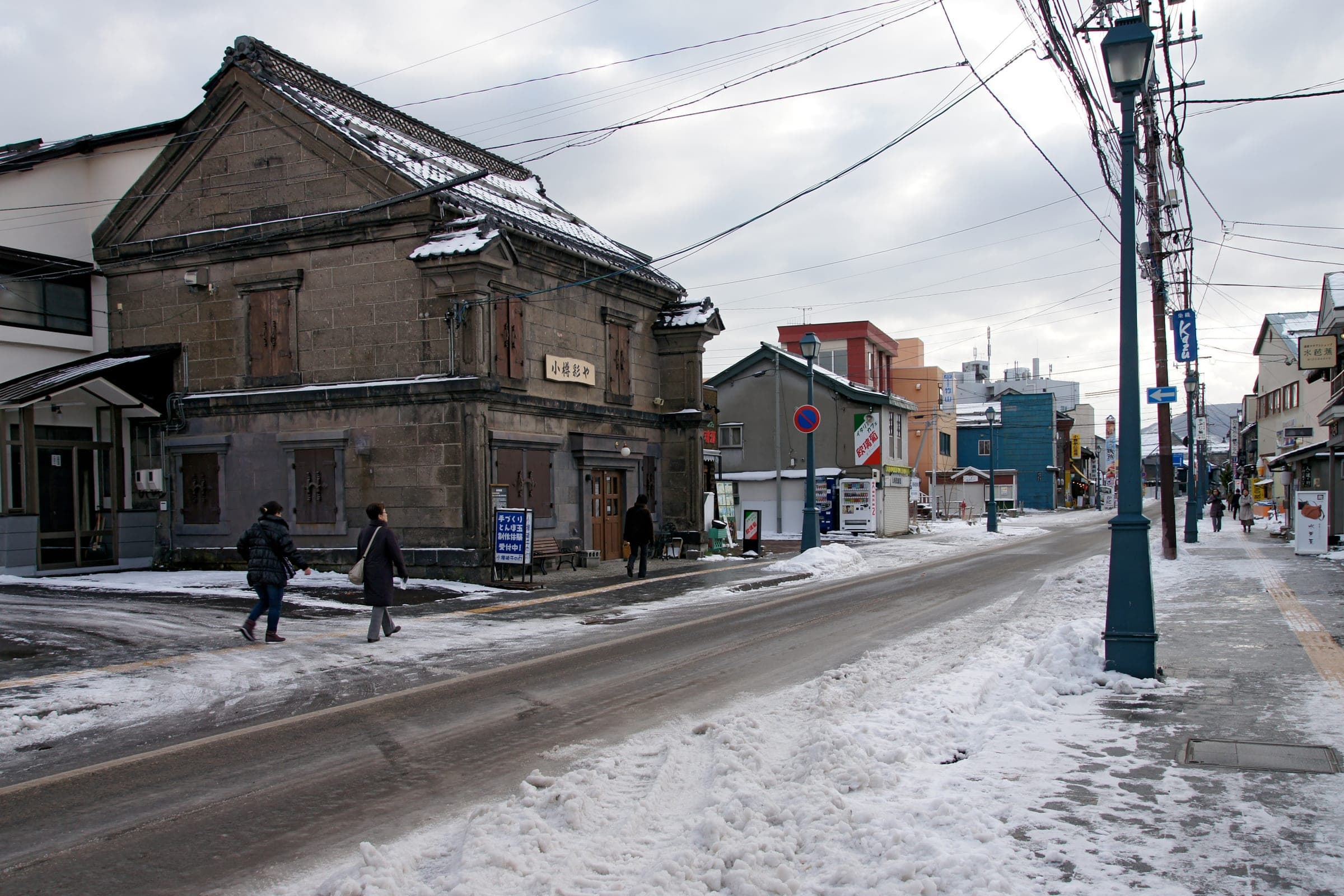 Snow lines Sakaimachi-dori and its old stone merchant houses, a short walk below the hotel in Otaru