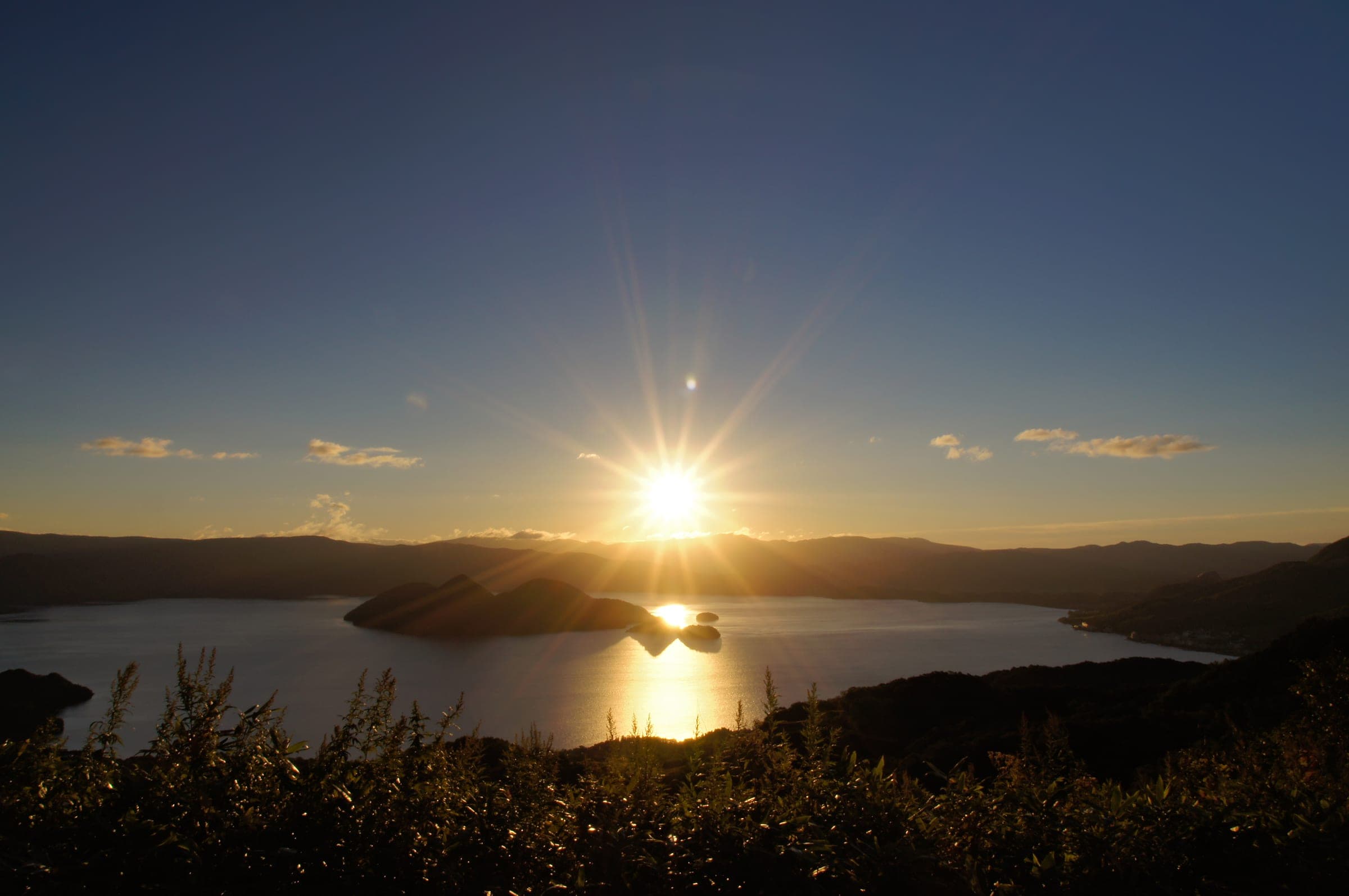 Morning sun rising over Lake Toya seen from The Windsor Hotel Toya