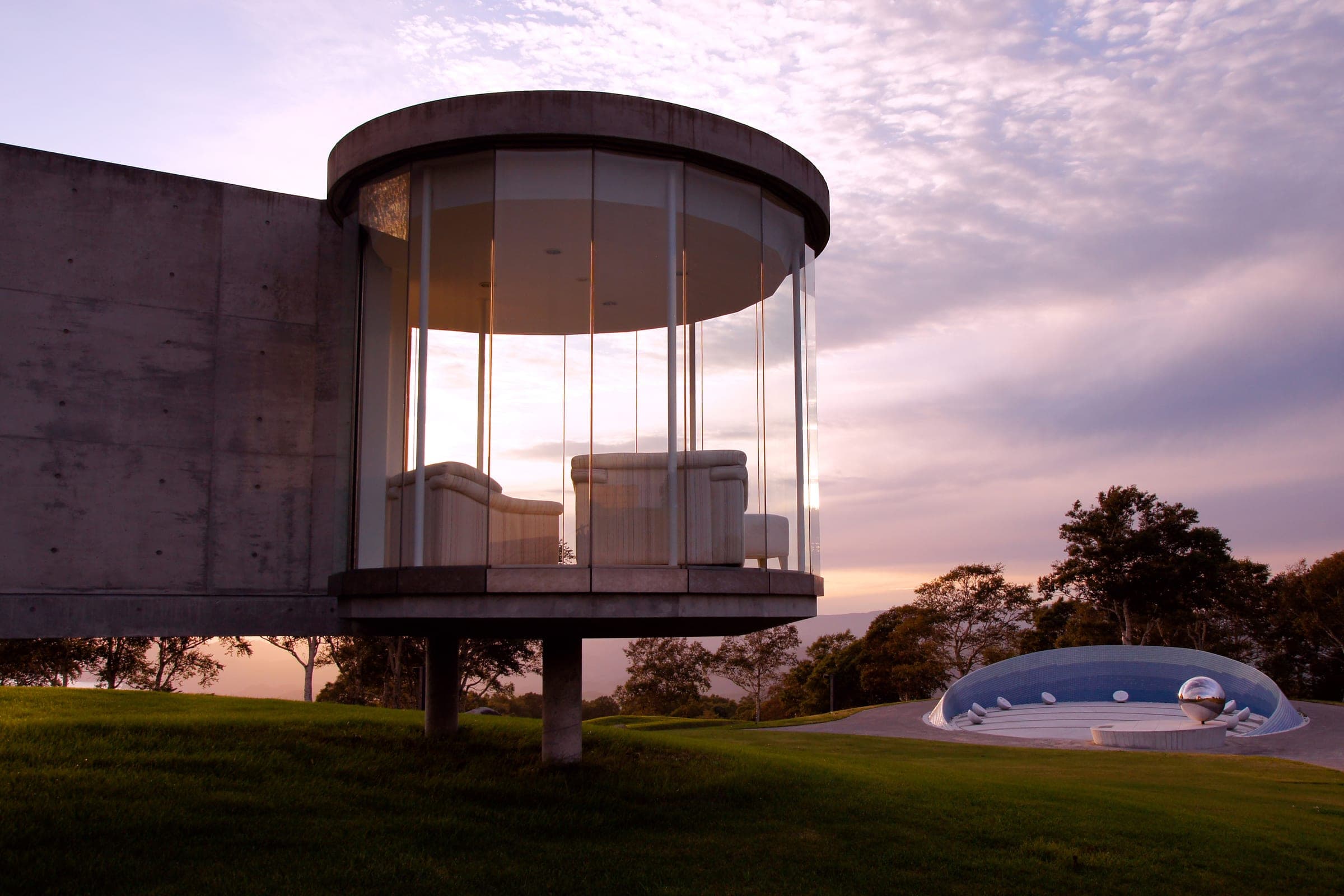 A glass pavilion at The Windsor Hotel Toya glowing at dusk