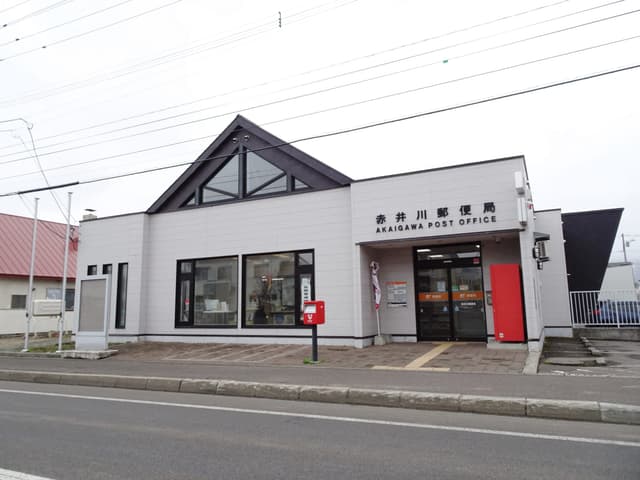 Akaigawa post office has white walls and a peaked glass gable