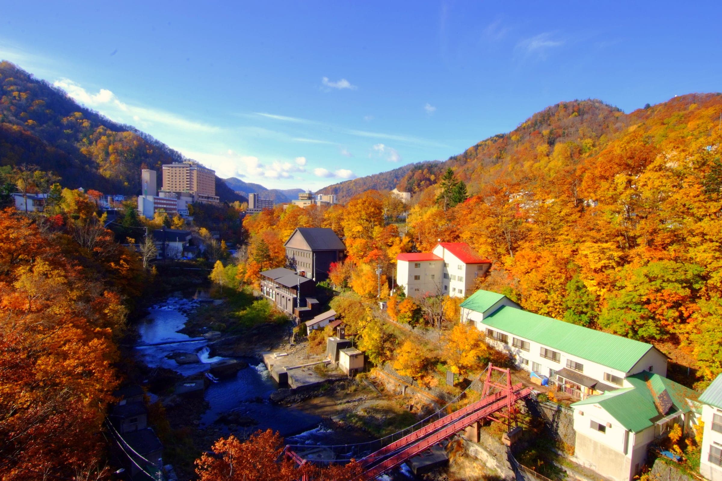 Autumn colour fills the gorge around the Jozankei Ohashi bridge and the onsen hotels