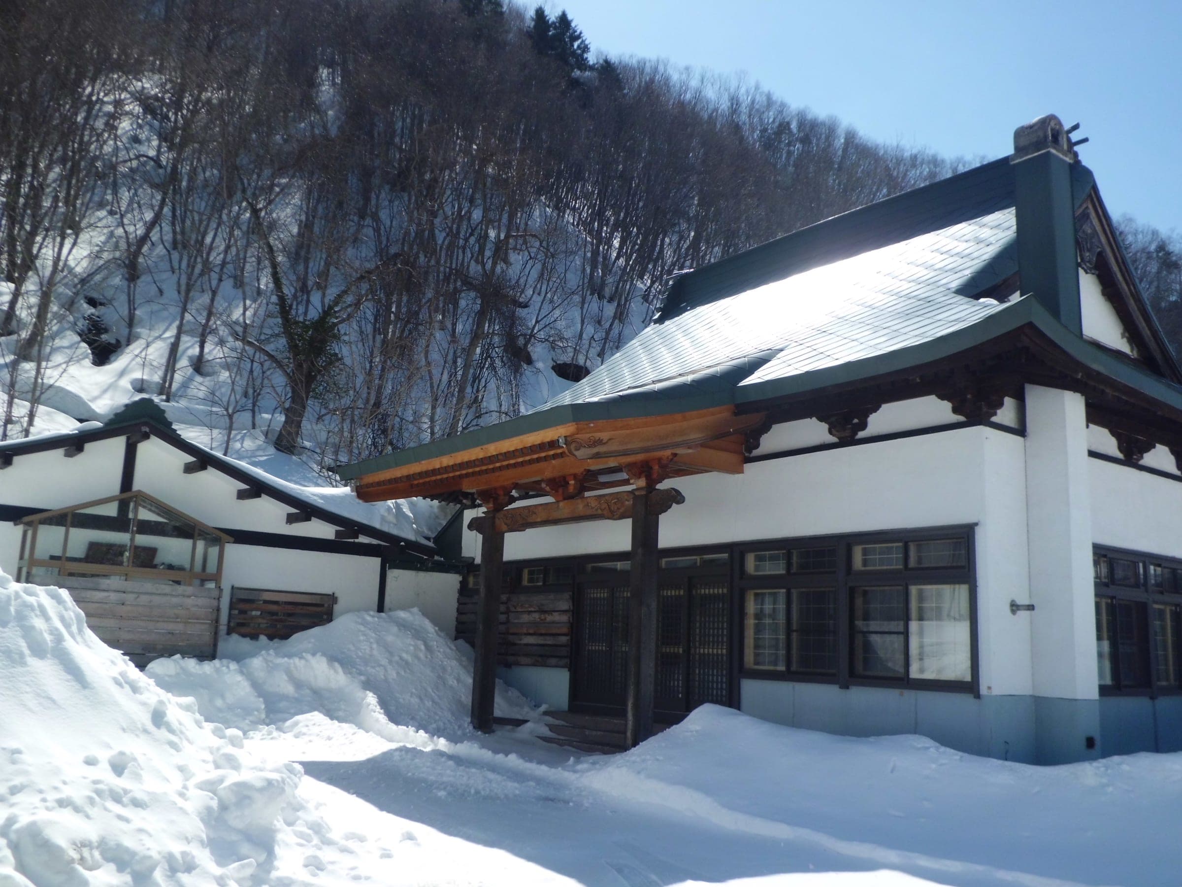 Deep snow lies against the white walls of Jozan-ji temple in Jozankei