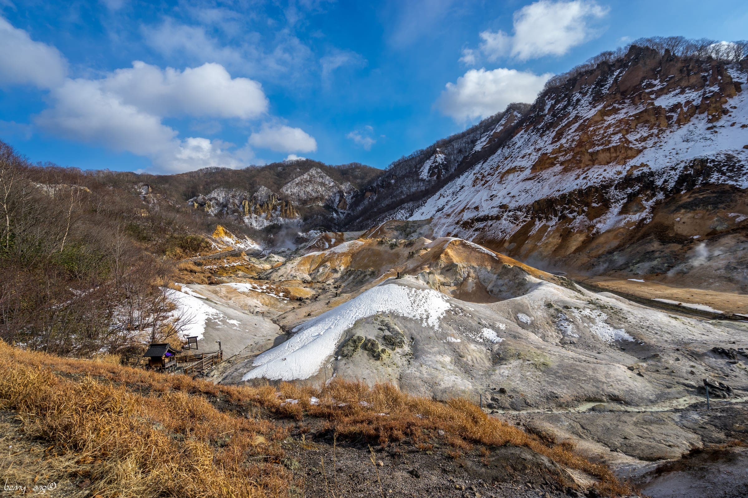 Snow dusts the steaming slopes of Jigokudani above Noboribetsu Onsen