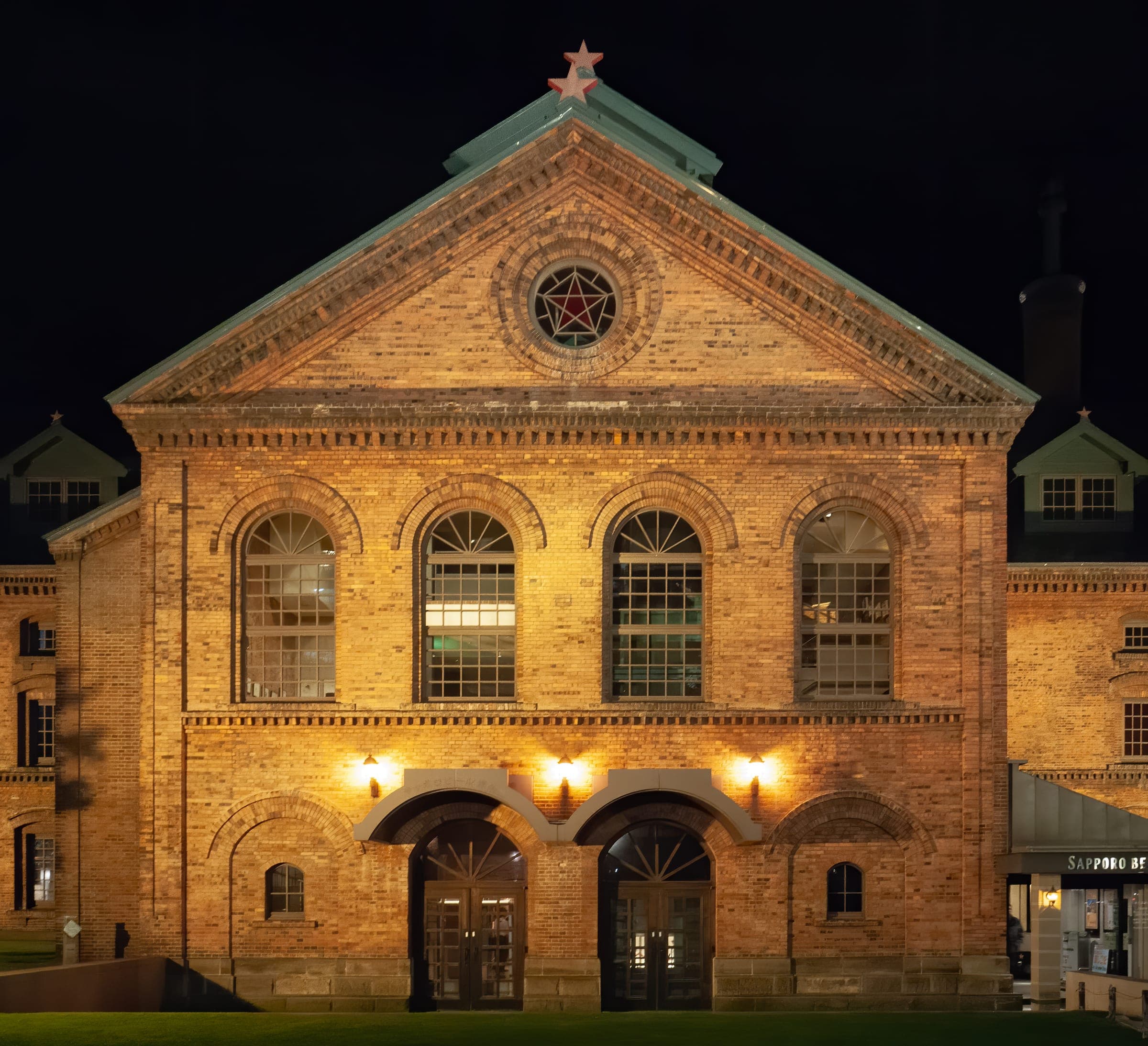 The red-brick Sapporo Beer Museum building lit up at night