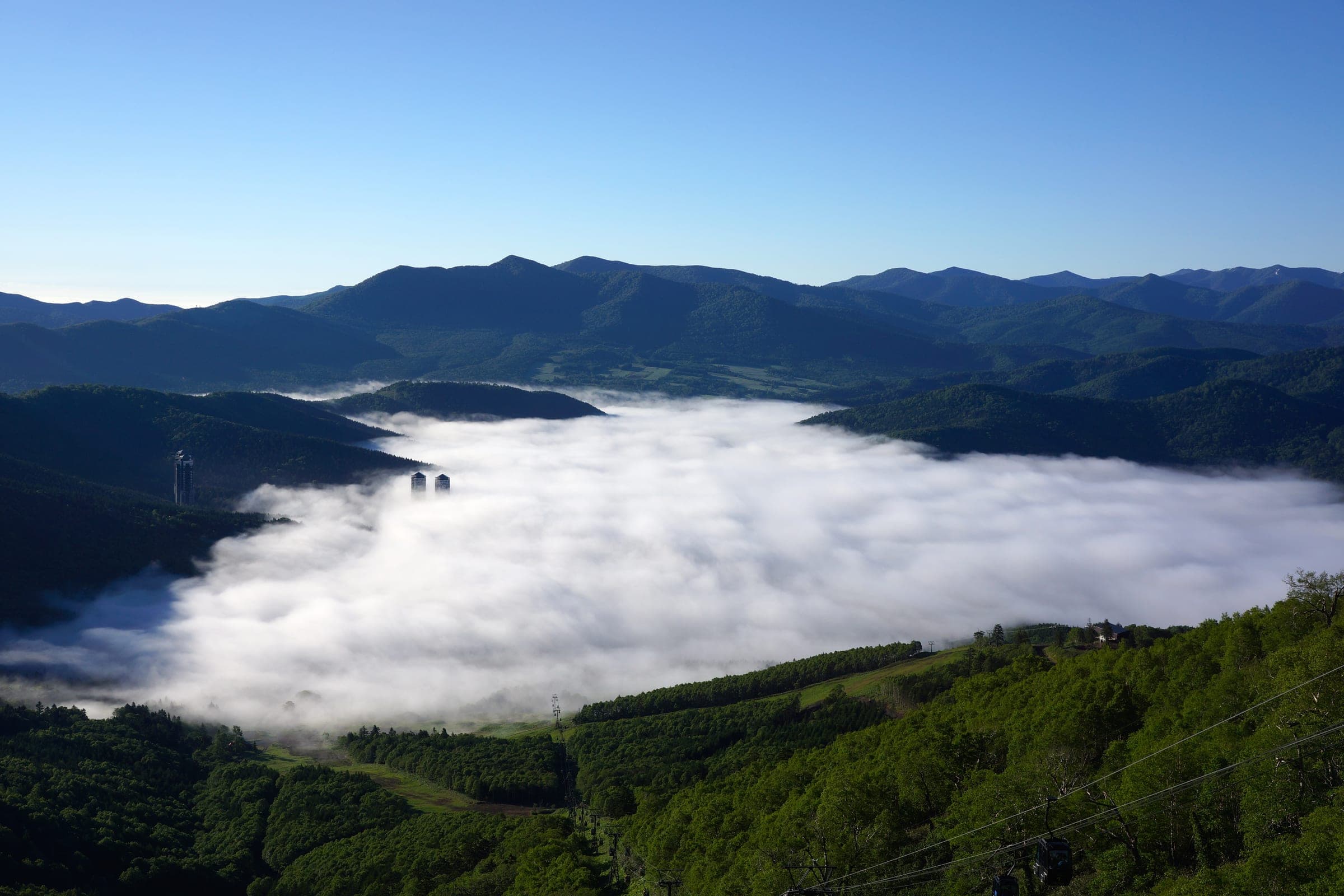 A sea of cloud fills the valley below the summit terrace at Tomamu