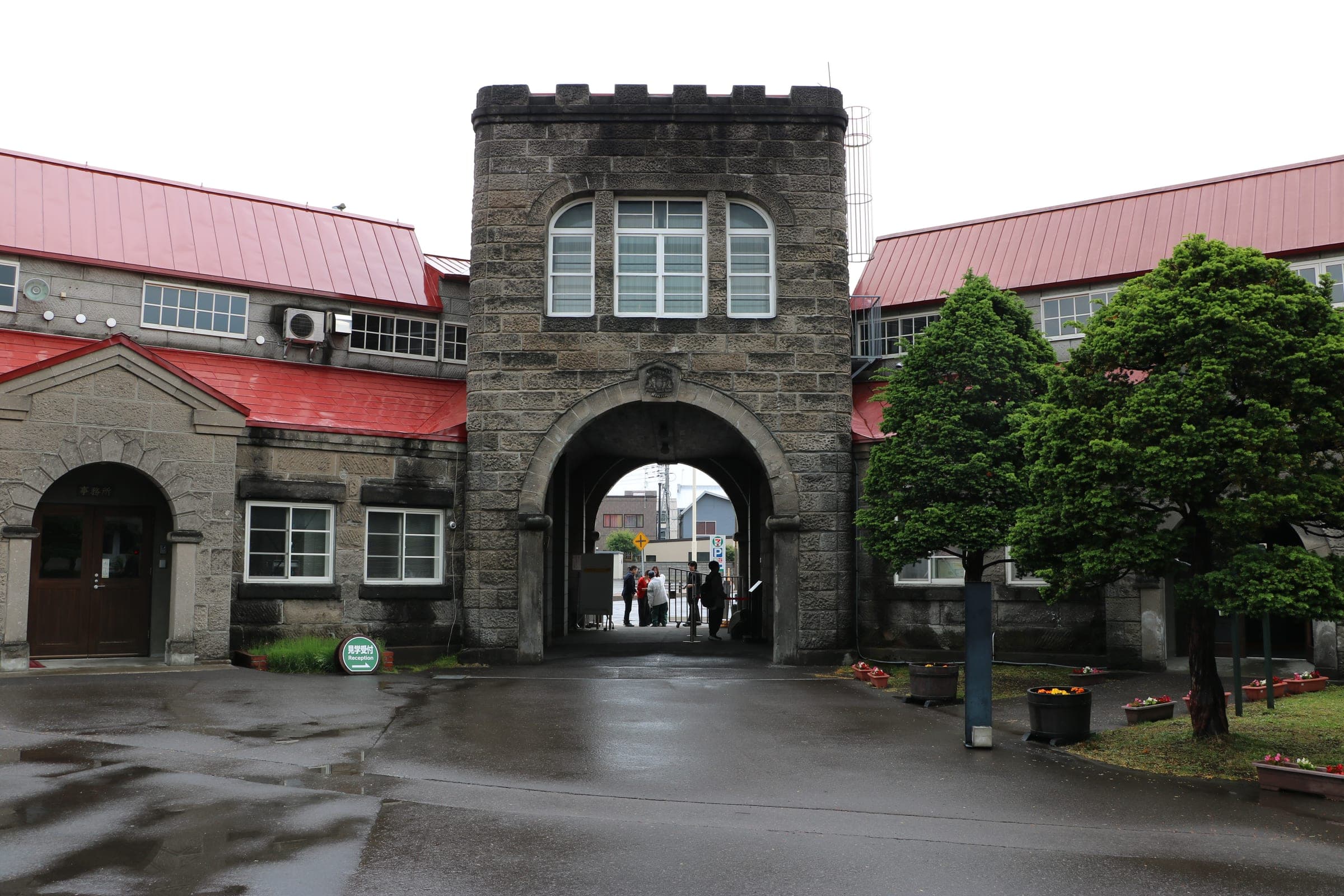 Red roofs and stone buildings inside the main gate of the Nikka Yoichi Distillery