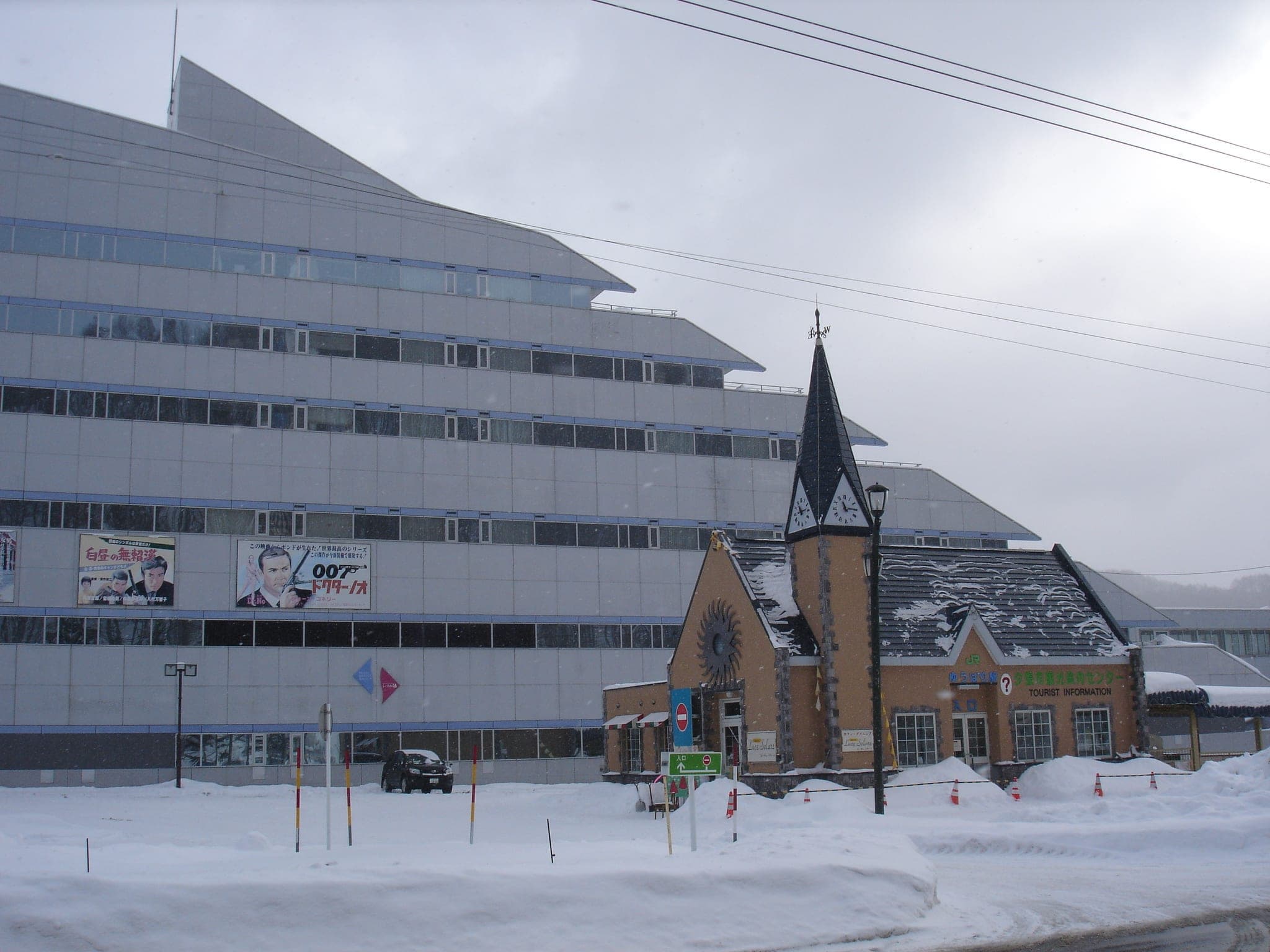 Hotel Mount Racey and a steepled building stand in fresh snow in Yubari